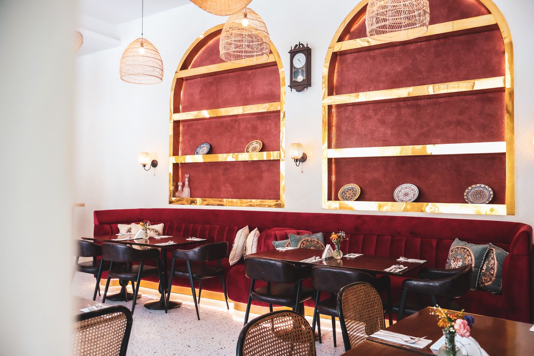 Burgundy banquettes and arched niches