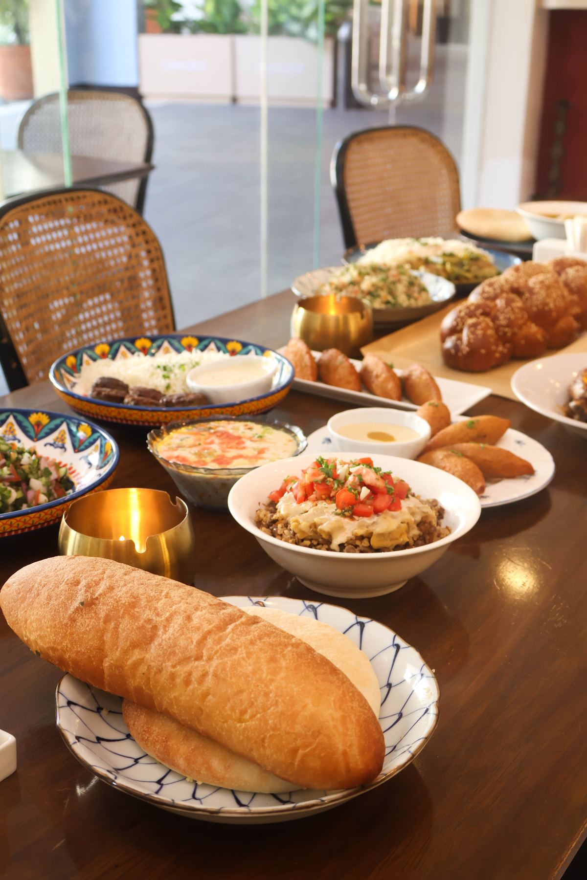 A spread of mezze, salads and bread on the table at Aziza